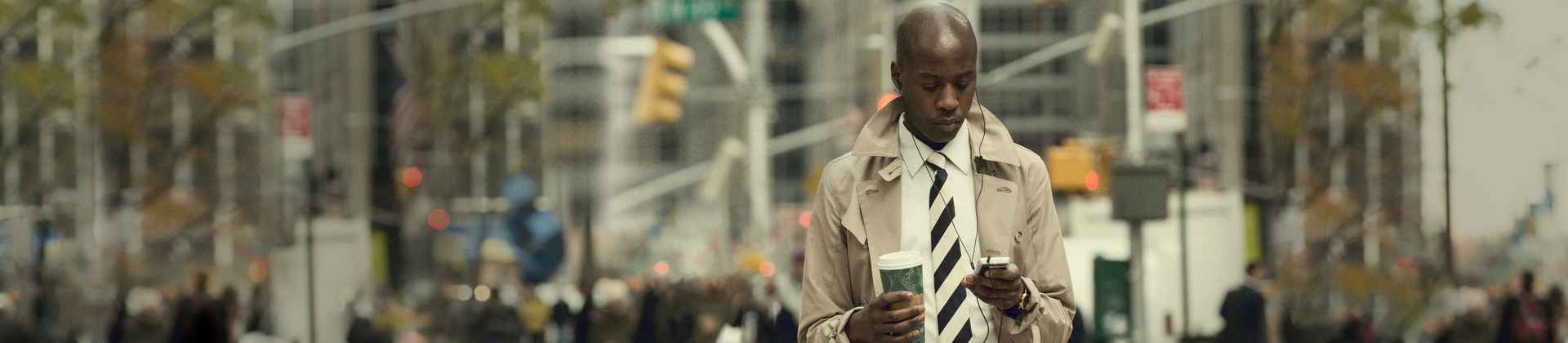 Finances_Man_Looking_At_Cell_Phone Finances_Man_Looking_At_Cell_Phone